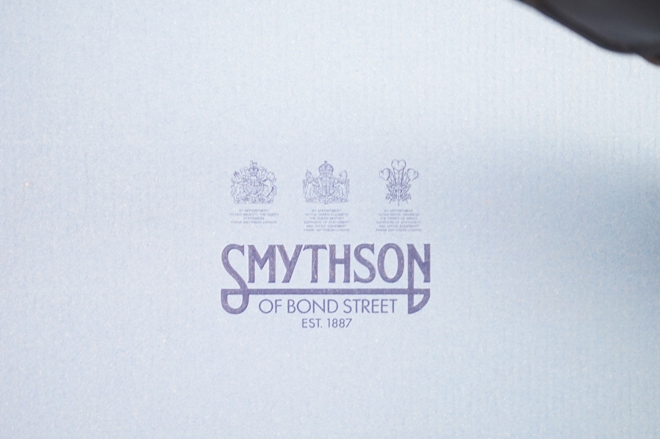 Smythson of London. A black leather notepad, 14cm, two moire silk address/telephone books, a pale grey leather purse,18cm, a Panama cornflower blue notebook, 14 cm and a duck egg blue purse, 20 cm. all boxed.